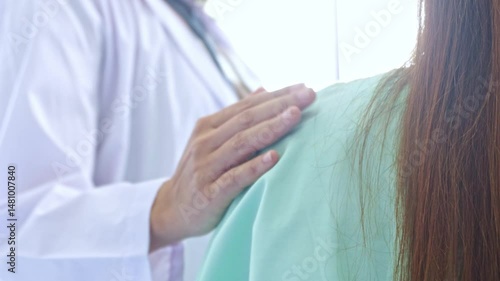 Female doctor's hands crossed her shoulders and gently touched her to encourage a female patient who was stressed from depression to help her relax.
