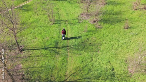 Gay couple walking in green park, aerial view