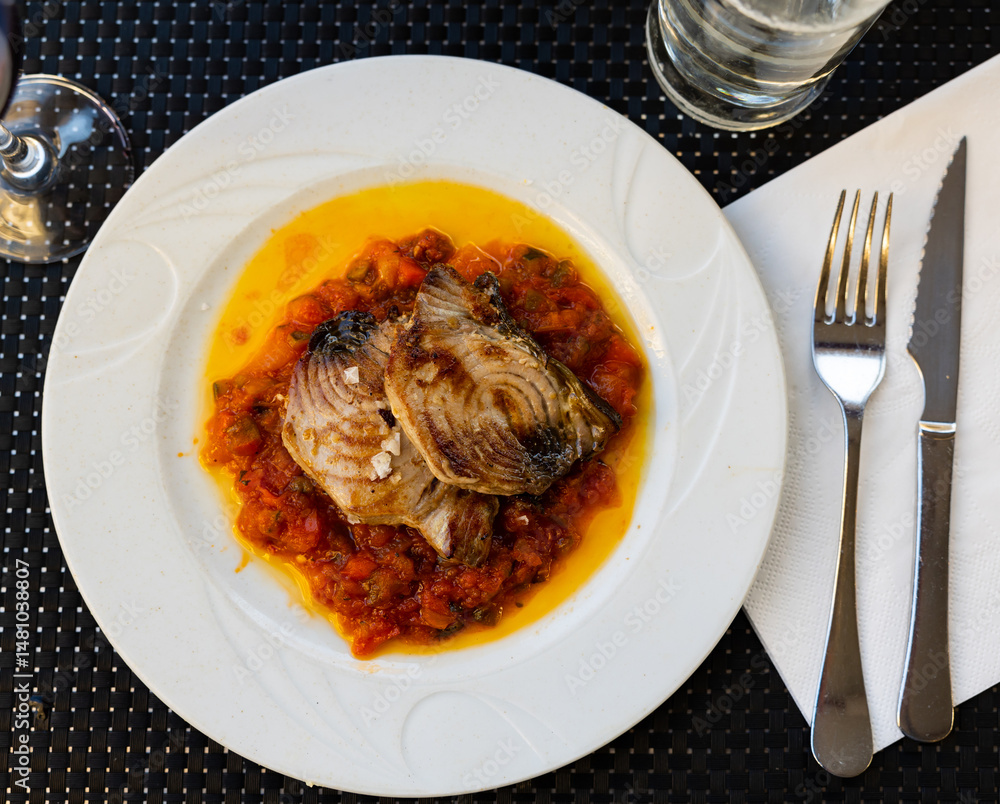 Stewed tuna fish with vegetables and samfaina sauce served on platter