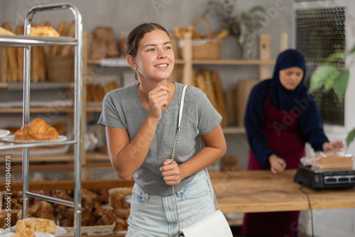 Obraz na płótnie Female customer choosing bread and other delicious pastries in the oriental bakery w salonie