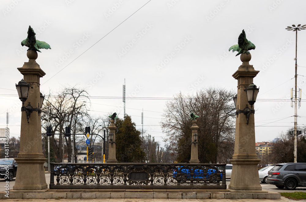 Busy traffic on ancient bridge over Perlovska River passes through Orlov Bridge. Historical architectural landmark. Bridges supports decorated with statues of eagles, symbol of freedom and defiance.