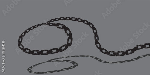 Long black metal chain looping and extending on gray background