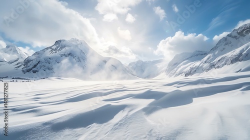 Snow Covered Mountain Range Under A Bright Sky With Cloud Formation