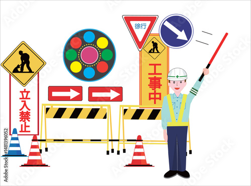 工事現場で交通誘導員が車に注意を促している。
