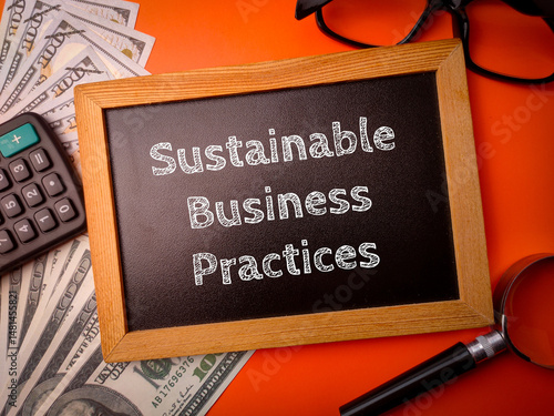 Top view wooden board with the word Sustainable Business Practices on a orange background