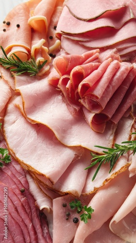 A vibrant assortment of deli meats garnished with herbs, showcasing various textures and colors for an appetizing presentation.
