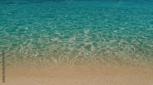Beautiful clear turquoise ocean water meeting a sandy shoreline