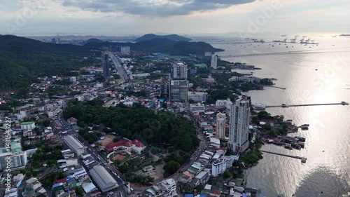 Aerial view of a coastal city with hills, buildings and streets.