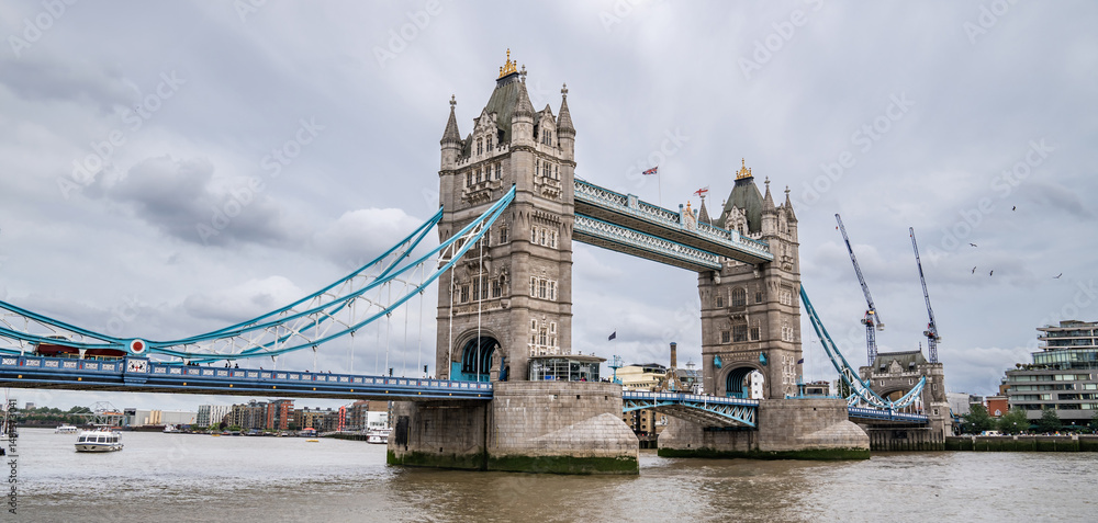 Obraz premium Tower Bridge Spans the Thames with Its Gothic Towers and Blue Cables, Remaining a Must-See Symbol of the City for Visitors in July 2023