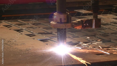 The hi-technology sheet metal manufacturing process by laser cutting machine. Close-up of laser cutting machine with flying sparks. CNC plasma cutter cut metal sheet. Gas cutting process at factory
