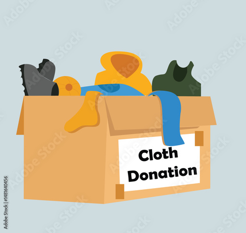 Clothes donation. Cardboard box full of different things. 