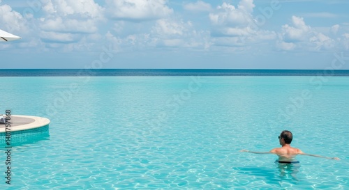 Photo of Man Swimming in Tranquil Turquoise Ocean Resort Pool