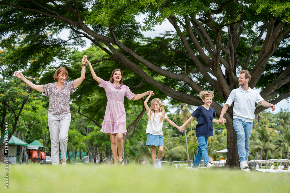 Fototapeta premium Happy family parent children having picnic outdoor activity. Enjoy happiness moment summer playing together including father mother son and daughter relaxing in the morning sunrise.