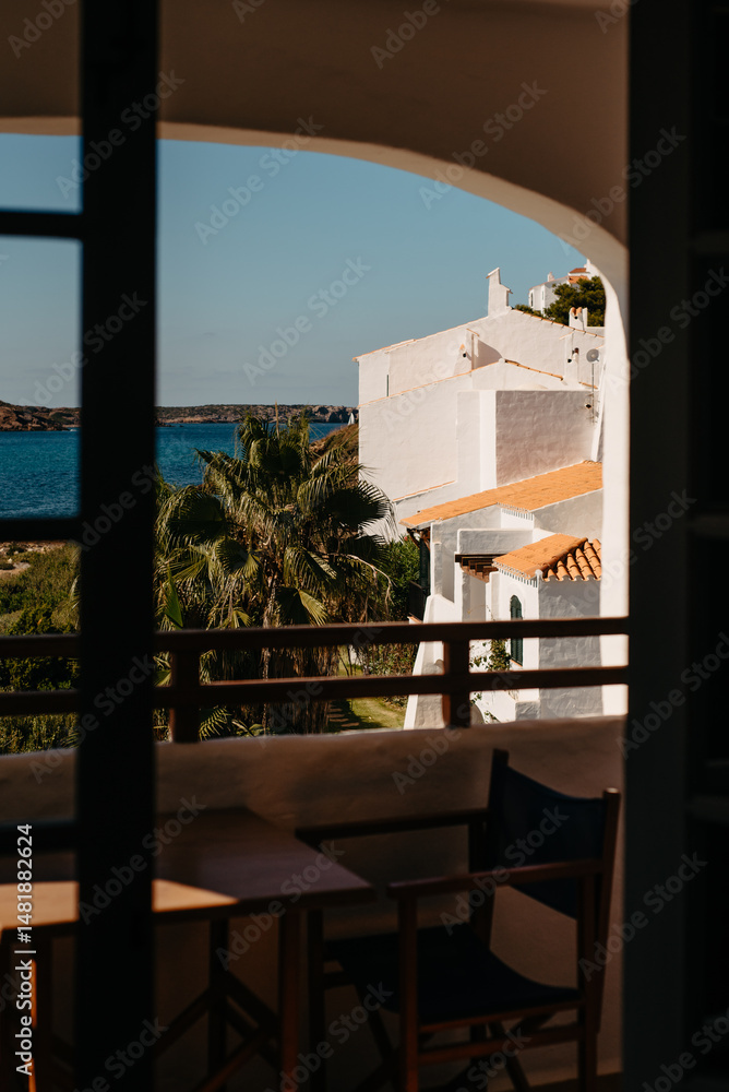 Fototapeta premium Balcony of Mediterranean Villas and Palm Trees in Fornells, Menorca