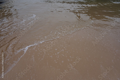 small wave in the white sand beach