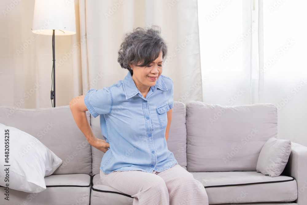 Senior health care backache sick, high blood pressure staying at home alone, woman suffering from overwork sitting on sofa massage on back, elderly grandmother in 70s unhealthy experiencing painful Senior health care backache sick, high blood pressure staying at home alone, woman suffering from overwork sitting on sofa massage on back, elderly grandmother in 70s unhealthy experiencing painful
