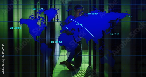 Crouching hoodie-clad technician accessing server racks in data center with LEDs, world map overlay