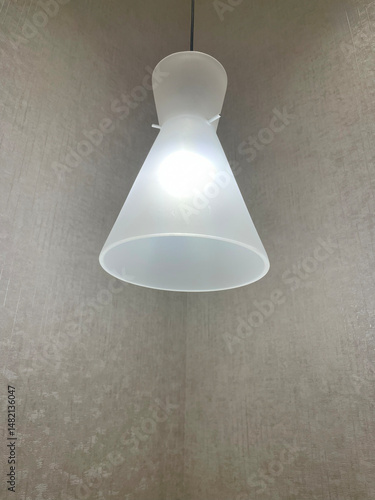 View of a cozy decorative lamp in a corner spending soft light