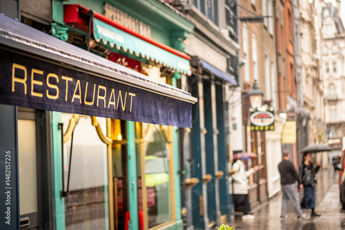 Central London west end street scene with restaurant text on left third of composition