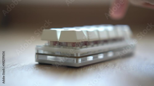 Close-up of a modern computer keyboard with sleek, metallic buttons.