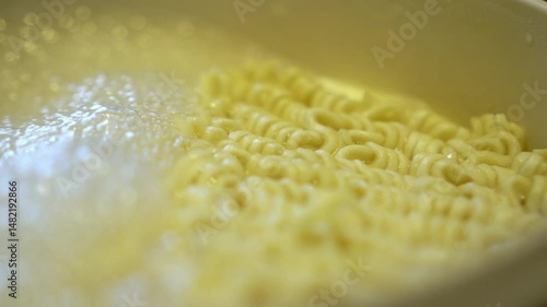Boiling pasta noodles in a pot of water on the stove.