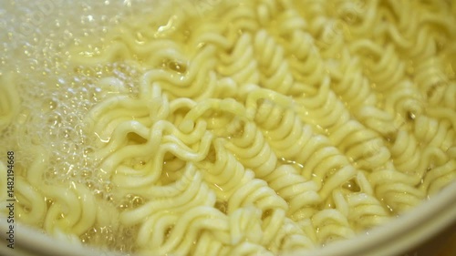 Close-up of boiling pasta noodles in a pot of hot liquid