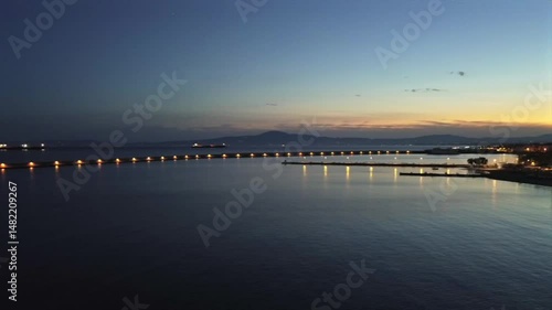 Wallpaper Mural Aerial night footage of iconic pier of Kalamata port during golden hour. Panoramic right pan view of the city 4K Torontodigital.ca
