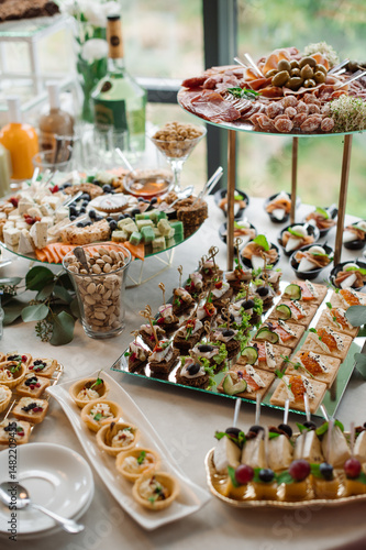 Wedding day. Buffet table with various types of snacks and sweets in the celebration hall