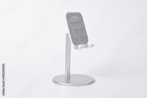 Metal alloy adjustable phone holder. Folding desktop phone stand isolated on white background.