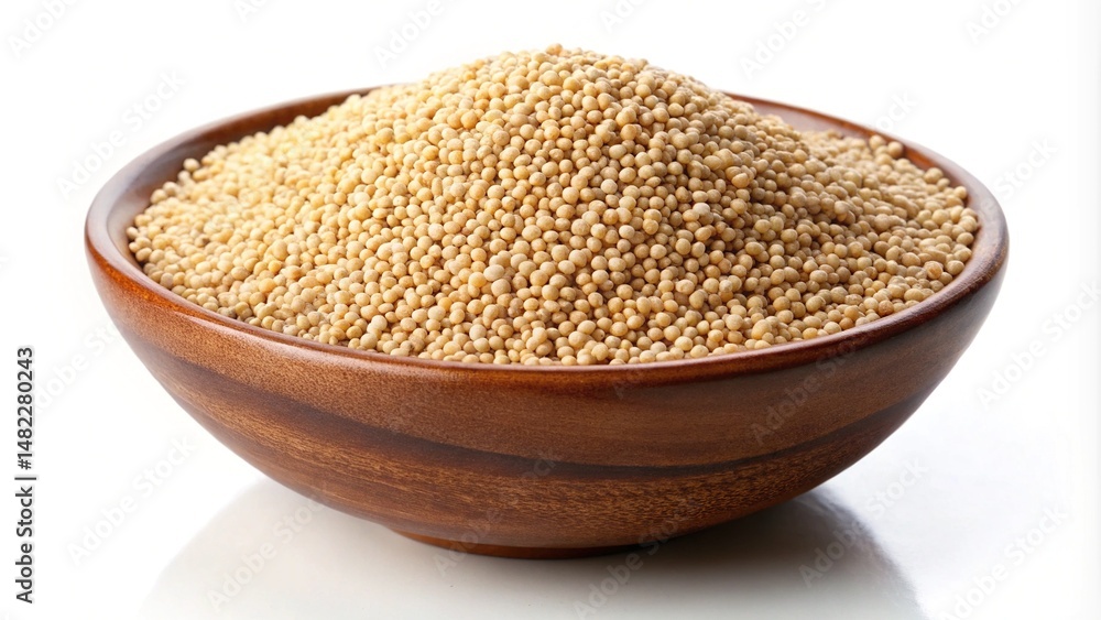 Wooden bowl filled to the brim with golden amaranth grains on white Wooden bowl filled to the brim with golden amaranth grains on white