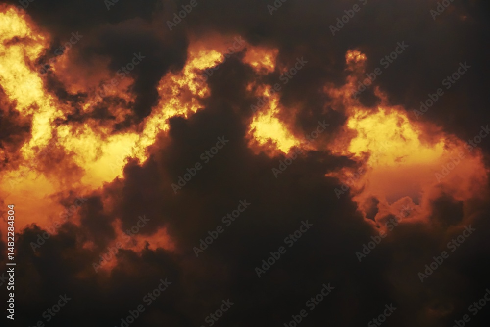 Fototapeta premium Vibrant orange clouds at sunset, a stunning view.