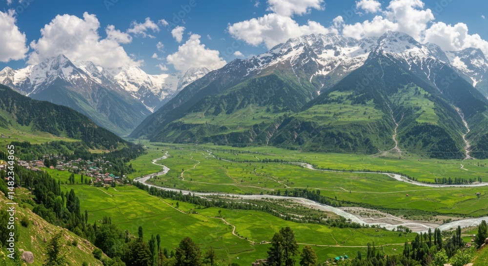 Fototapeta premium Panoramic view of lush green valley surrounded by majestic mountains under clear skies