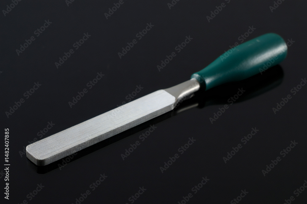 Fototapeta premium Fine Cut Metal File with Ergonomic Green Handle on Black Background