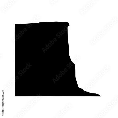 Silhouette of a large rock formation or plateau with a steep cliff