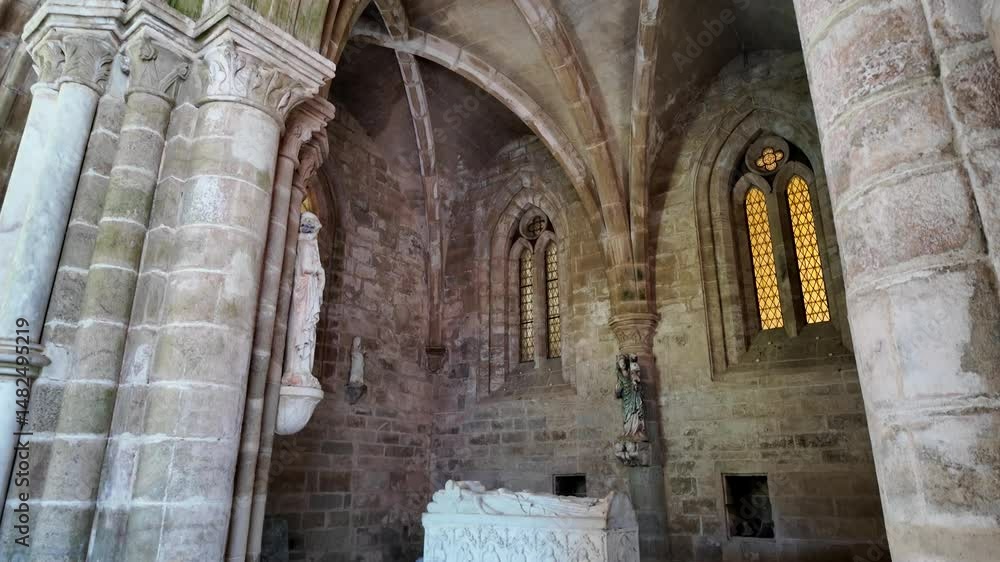 A serene interior shot of the Cathedral of Évora cloister, featuring intricate architecture, statues, and stained glass windows A serene interior shot of the Cathedral of Évora cloister, featuring intricate architecture, statues, and stained glass windows