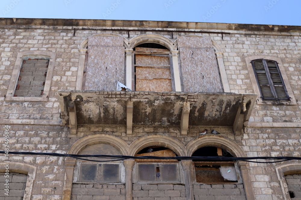 Fototapeta premium Ruins of old houses in the center of a big city