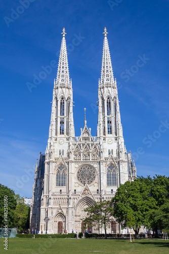 Votivkirche Cathedral in Austria, with its iconic twin spires rising against a cloudless blue sky. 