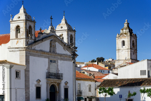 Lagos, Faro district, Algarve, Portugal, Europe - old town, Infante Dom Henrique square, Henry the Navigator Square, Santa Maria church at left, Santo Antonio church tower in renovation at right