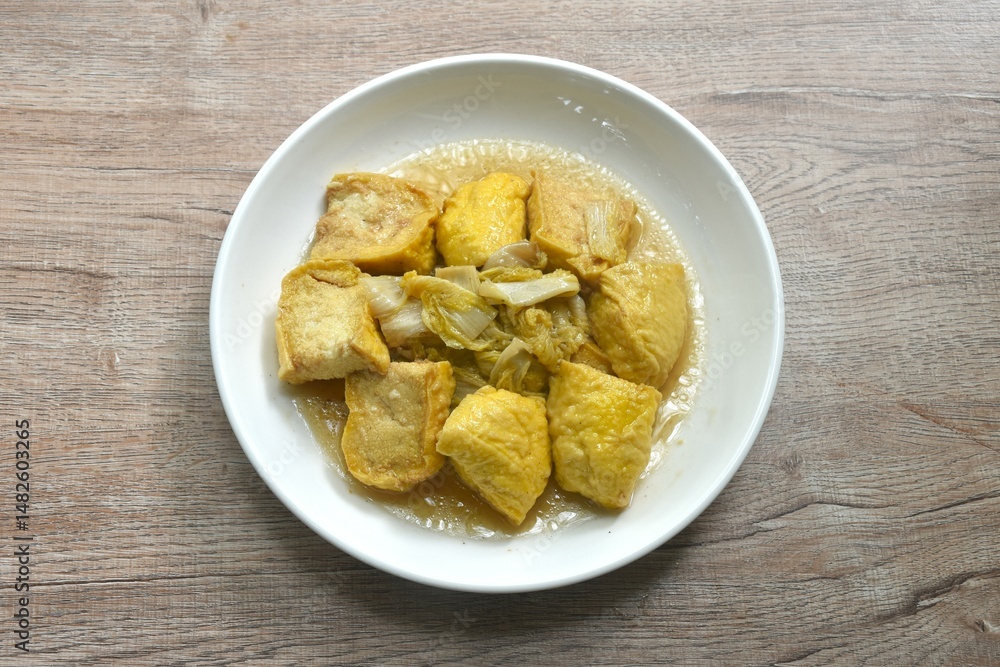 fried cabbage with slice soft yellow tofu vegetarian food on plate fried cabbage with slice soft yellow tofu vegetarian food on plate