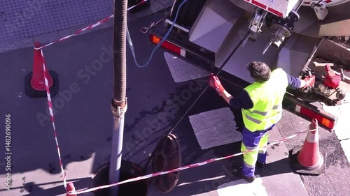 sewer truck with sewage utility worker to cleaning the drain line in city street , video footage  hd