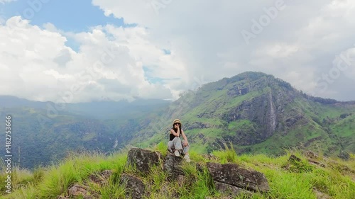 Woman Enjoying Panoramic View at Adams Peak – Hiking Adventure in Sri Lanka. Iconic hiking destination in Ella with stunning lush landscape views. Sri lanka island mountains.