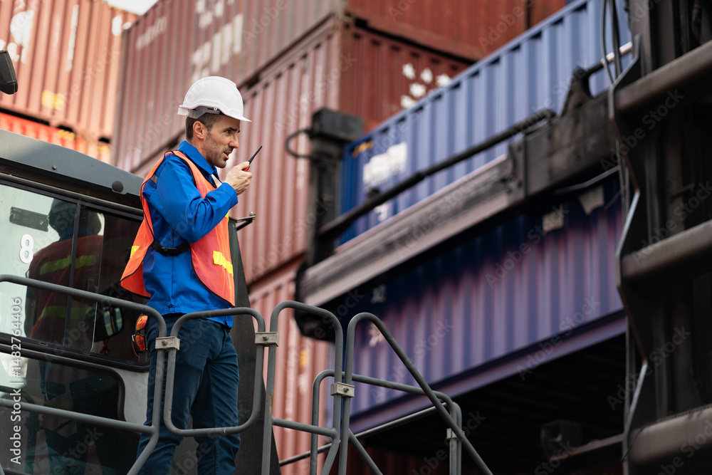 Caucasian man engineer worker working with walkie talkie and talking on Reach Stacker at container site Caucasian man engineer worker working with walkie talkie and talking on Reach Stacker at container site