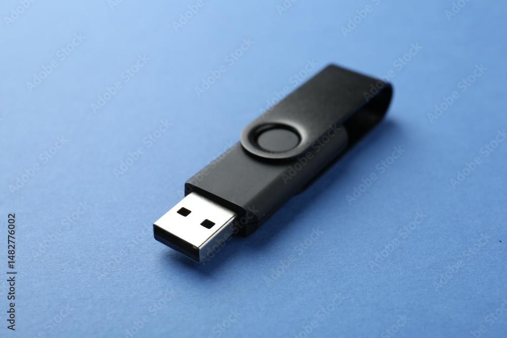 One flash drive on blue background, closeup One flash drive on blue background, closeup