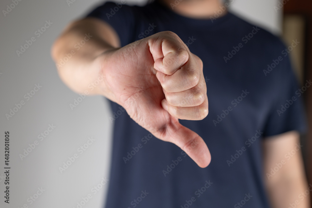 custom made wallpaper toronto digitalA man makes a thumbs down gesture. A man makes a displeased gesture by pointing his thumb down.