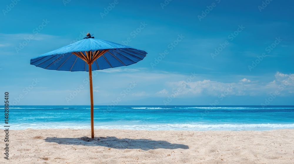 Blue umbrella on a sandy beach with clear sky and ocean in the background, representing vacation and relaxation Blue umbrella on a sandy beach with clear sky and ocean in the background, representing vacation and relaxation