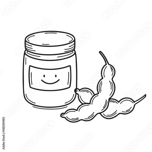 A tamarind beside a jar of paste on a cooking counter