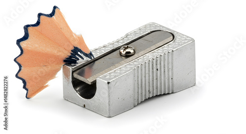 Close Up of a Silver Pencil Sharpener with Wooden Shaving on White Background