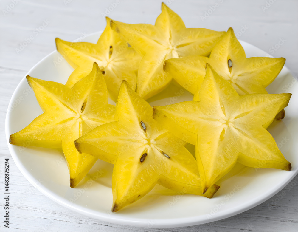 Fototapeta premium Sliced Starfruit on a Round Plate