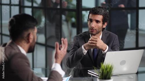smiling businessman shaking hands with his business partner