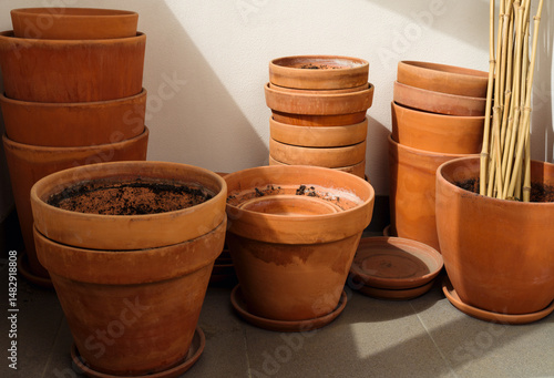 Stacks of plant pots, used old empty terracotta flower pots